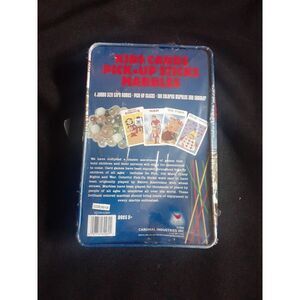 Tin full of kids cards, pick-up sticks and marbles